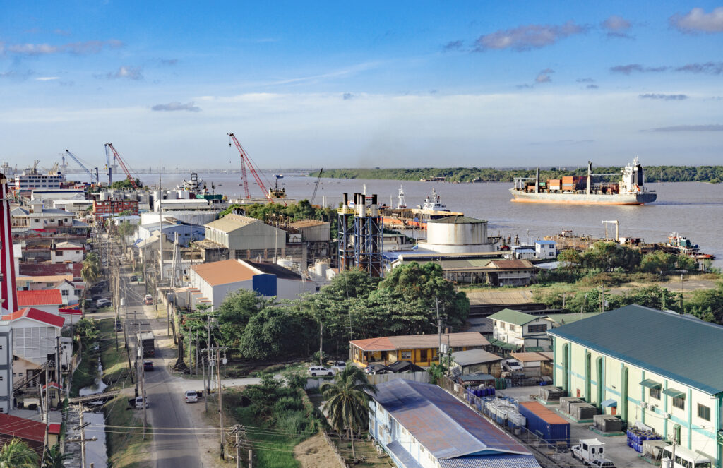 Georgetown, Guyana with industrial activity along the waterfront of the Demerara River and a cargo ship in the background