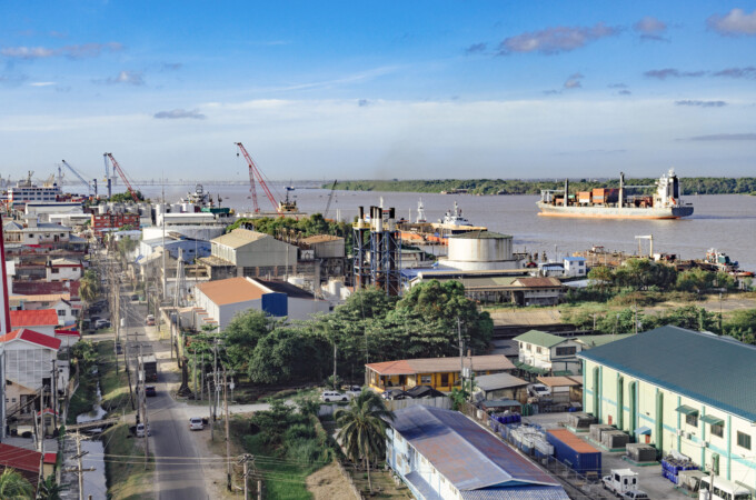 Georgetown, Guyana with industrial activity along the waterfront of the Demerara River and a cargo ship in the background